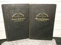 Front covers of both memorial address books showing titles and decorative cloth bindings