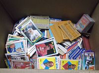 Top view of box filled with assorted loose sports trading cards
