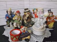 Group shot of all seven porcelain clown items