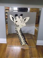 Front view of framed giraffe mirror