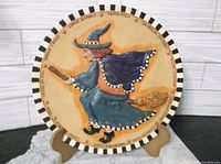 Front view of Kurt Adler 3D witch plate on stand