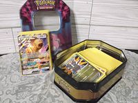 Tin containing large stack of Pokémon cards and Persian GX card displayed