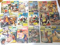 All 18 comics laid out on table, top view