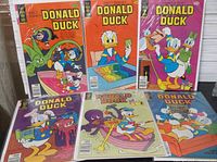 Six bagged and boarded Donald Duck comics displayed