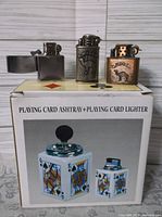 Box showing playing card ashtray set with three lighters on top