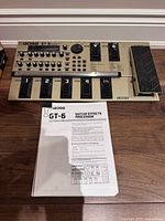 Top view of Boss GT-6 effects processor and manual