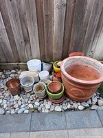 Group view of assorted pots against fence
