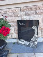 Entire framed poster leaning against wall showing artwork and frame