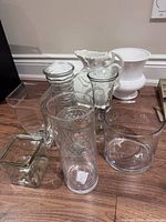 Group view of all glass and ceramic vases on floor