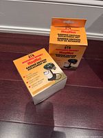 Two boxed Mosquito Magnet Garden Edition replacement nets on floor