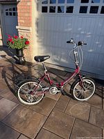 Full side view of burgundy Schwinn folding bicycle