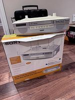 Sony ICF-CD523 radio on its original box with Sony boombox visible behind