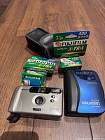 Front view of Sony Walkman, Nikon EF300 camera, Nikon case, four Fujifilm Superia X-TRA 400 film rolls