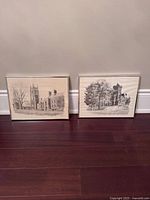 Both framed prints side by side against wall showing relative size and frames