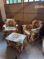 Full view of two armchairs and ottoman