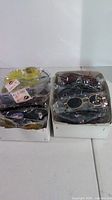 Two cartons filled with packaged sunglasses
