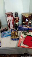 Overview showing angel box, nutcracker, ceramic Santa candle holder box, lights and hook packs