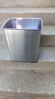 Front view of rectangular chrome metal wastebasket