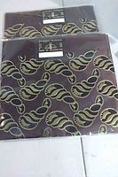 Both sealed Gele fabrics showing design and packaging.