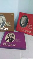 Front view of three Time Life box sets: Mozart (brown), Tchaikovsky (red), Berlioz (purple)