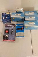 All boxed items laid out: Intel CPU, six X10 boxes, DC adapter, Dynex reader