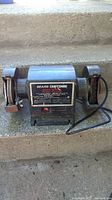 Front view of Sears Craftsman bench grinder showing both wheels and power cord