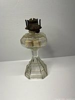 Full view of clear pressed glass oil lamp