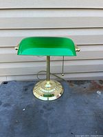 Front view of brass-tone bankers lamp with green glass shade