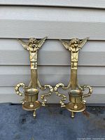 Full view of both matching brass sconces showing overall design