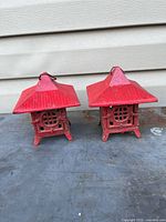 Both red cast iron pagoda lanterns side by side showing overall form