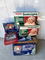 Stack of all boxed light sets showing brands and quantities