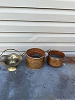 All three metal pieces side by side