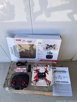 Full set showing box, drone, controller, accessories and manual