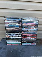 Two vertical stacks of ~50 DVD cases