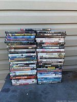 Two stacks of assorted DVD movies showing overall quantity