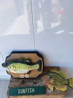 Overall lot with Big Mouth Billy Bass plaque and Sunfish sign