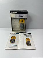 Front view of boxed Garmin eTrex GPS unit with manuals displayed