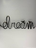 Front view of entire metal "dream" sign