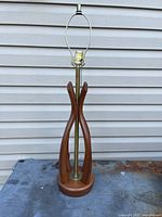 Full view of teak table lamp showing overall form and harp
