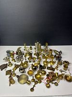 Wide view of entire collection of miniature brass items on tabletop