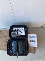 Drone, controller, cable, manual inside carrying case