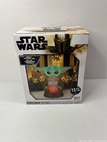 Front of sealed retail box showing The Child inflatable and branding