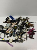 Overall view of mixed pile of wristwatches