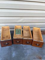 All four wooden sewing machine drawers front view