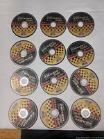 Twelve identical Indura Gold cutting discs laid out in rows