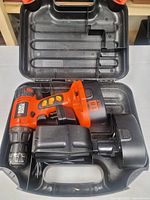 Drill, battery, charger in open carry case