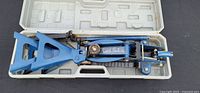 Hydraulic trolley jack inside opened plastic case