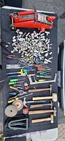 Full lot overview showing jack, large pile of sockets, hand tools laid out
