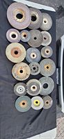 All 17 grinding wheels laid out to show range of sizes and condition