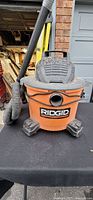 Front view of Ridgid WD09700 wet/dry vacuum with hose